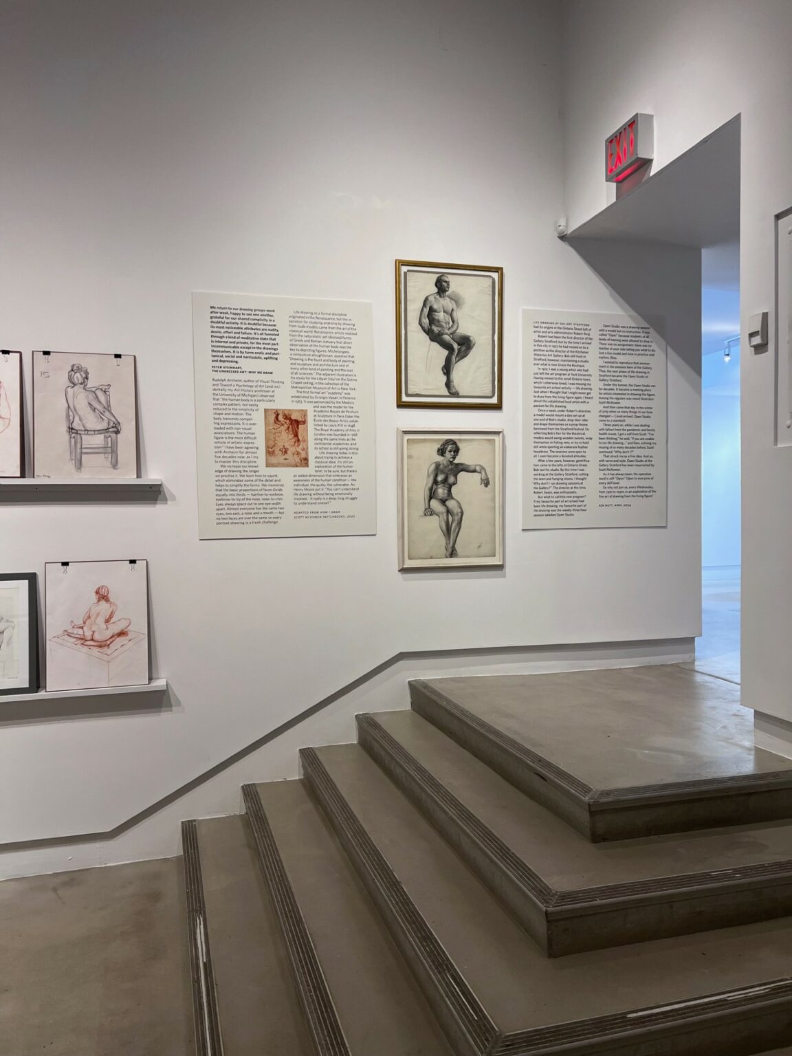 Stairs with drawings hung on surrounding walls