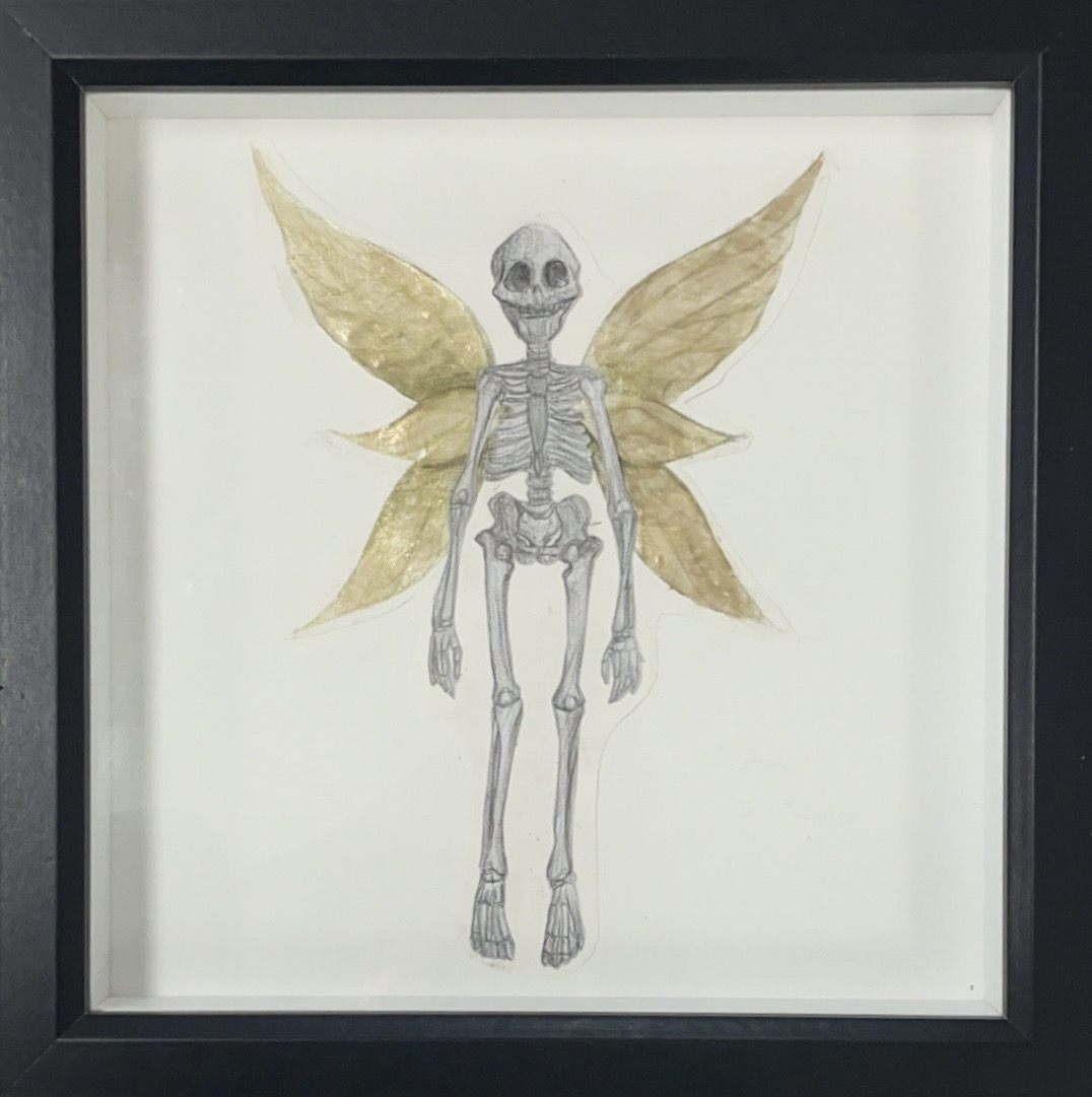 small skeleton drawing with collaged wings attached